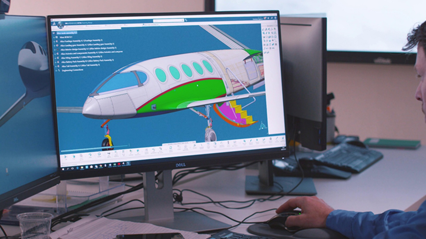 Computer monitor displaying a 3D engineering assembly in CAD software with an AI assistant interface for design review and model analysis
